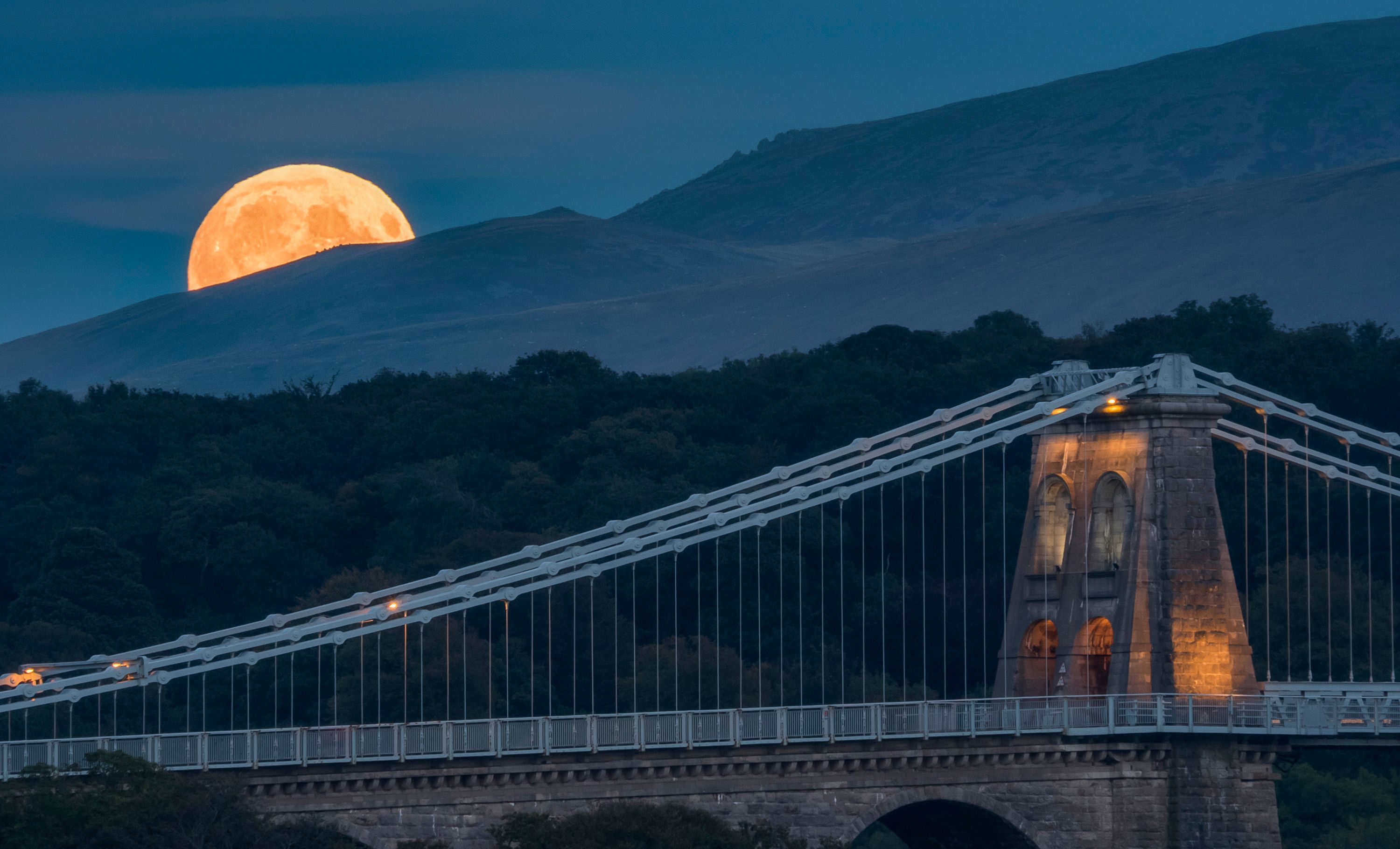 Full moon rises by Menai suspension bridge