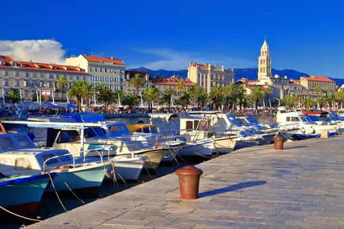 Old buildings and Venetian church tower behind sunny harbor on the Adriatic sea cost, Split, Croatia