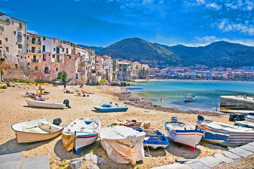 Wooden fishing boats on the old beach of Cefalu, Sicily, Italy.