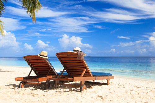 Two beach chairs on the tropical sand beach