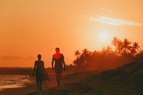 Footsteps, walk couple on the sunset beach