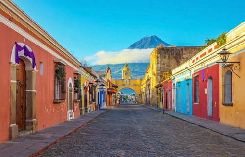 Cityscape in the main street of Antigua city with the Agua volcano in the background, Guatemala.